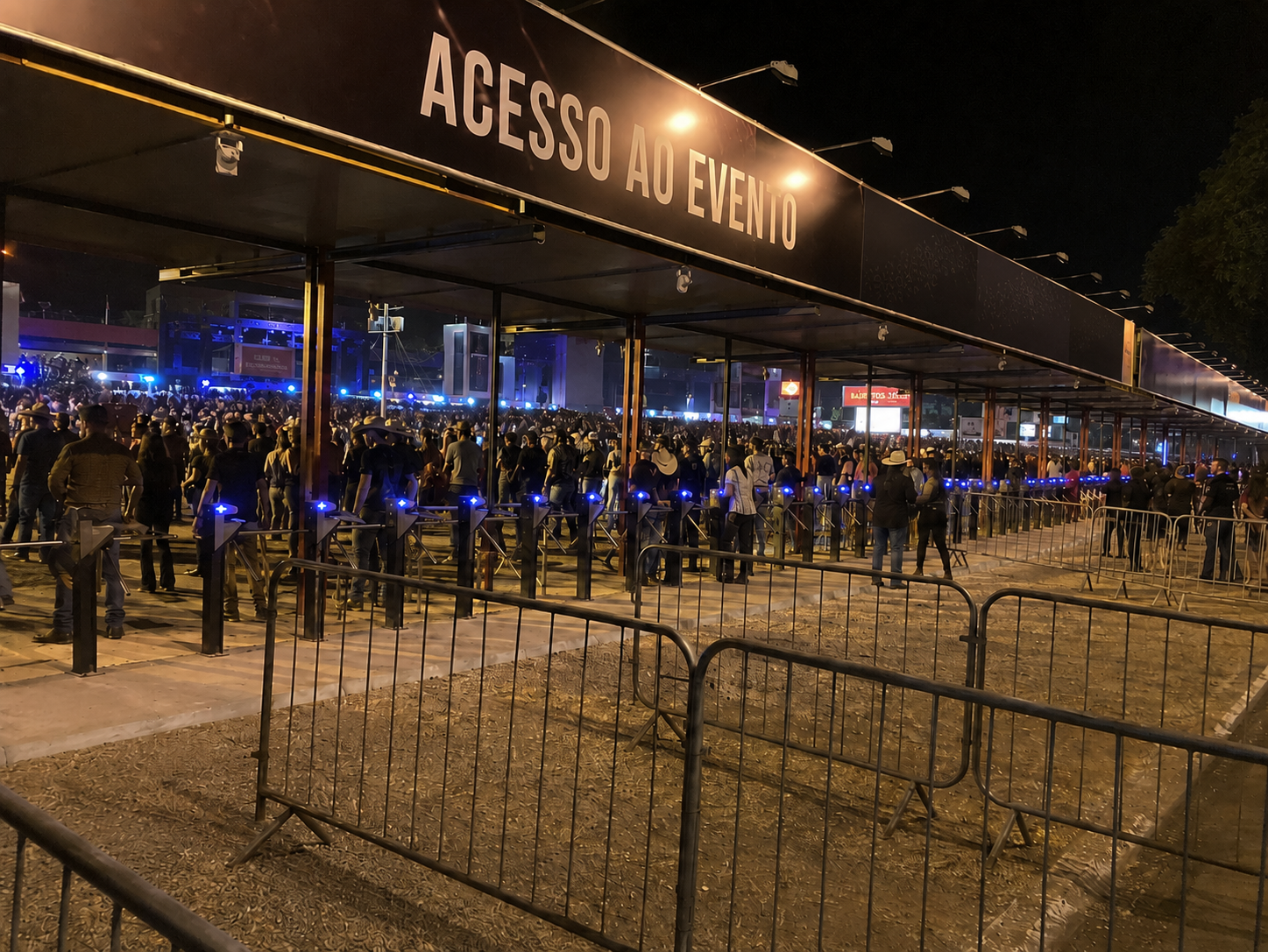Acesso ao evento monitorado pela QTI — público em fila nas catracas de entrada de um rodeio